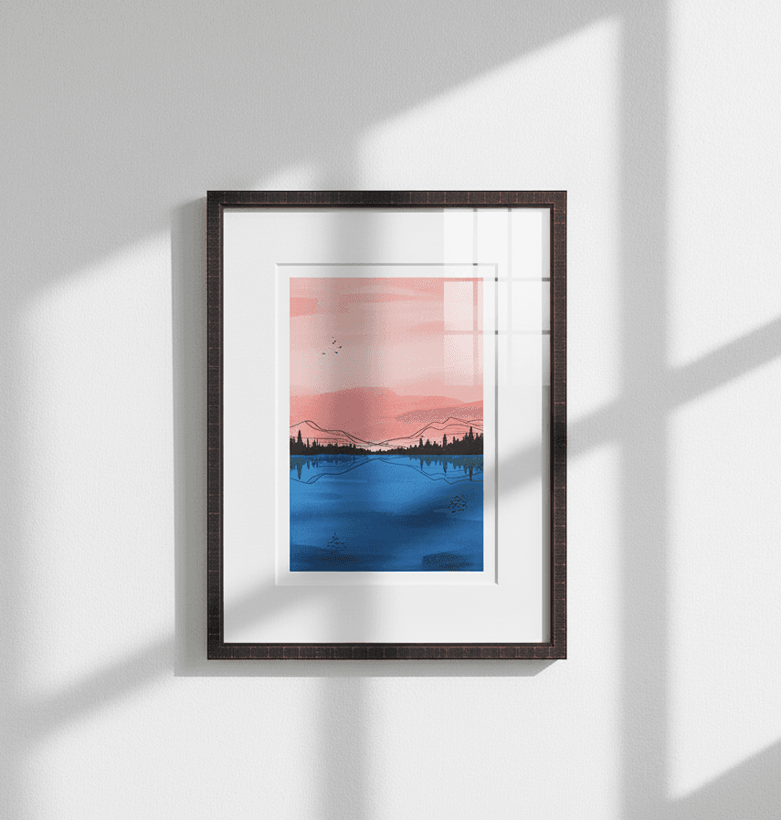 Dark wood picture frame with white mat displays minimalist landscape painting in pink and blue hues against white wall with sunlight