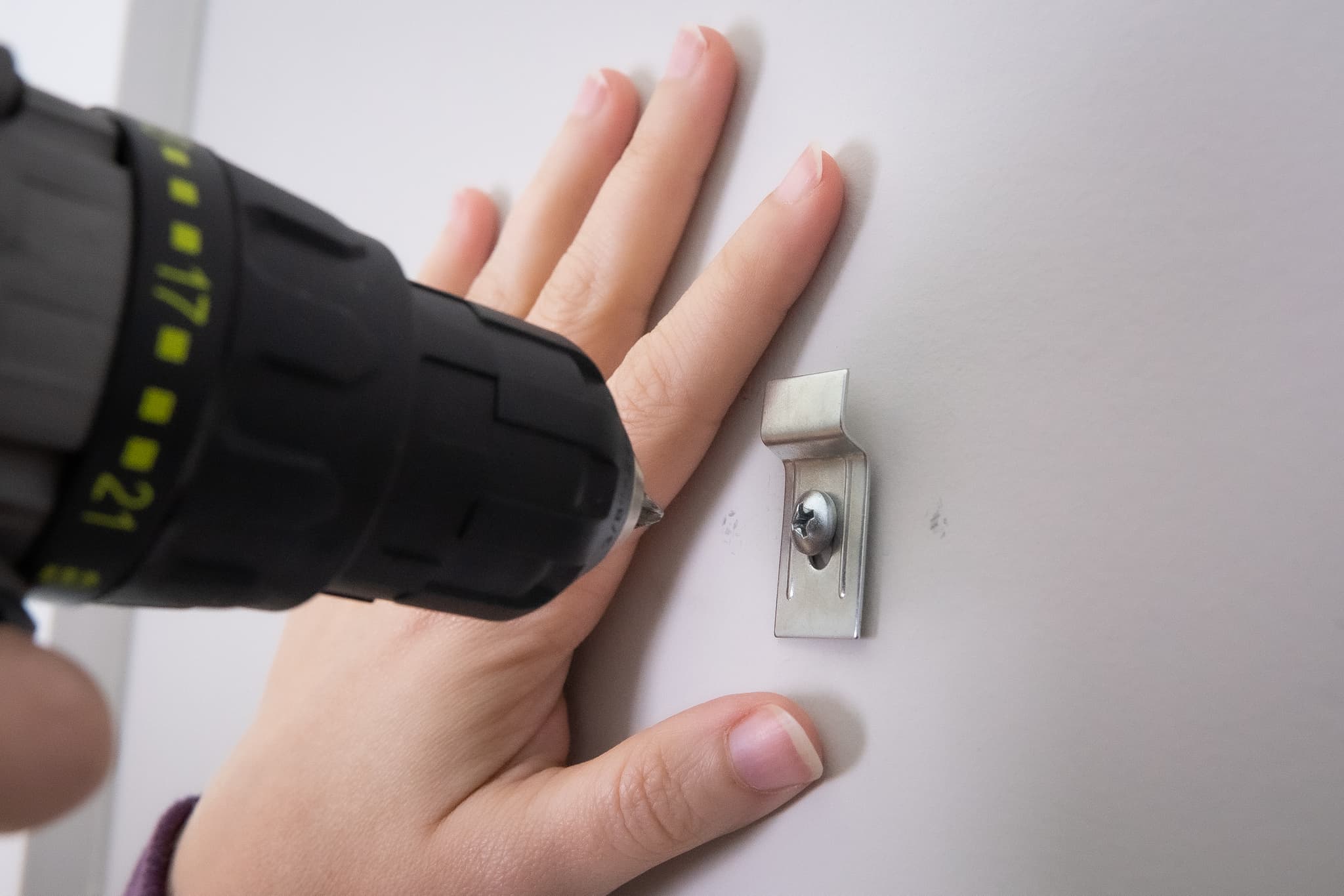 Installing wall bracket with security T-screw for theft-deterrent mounting